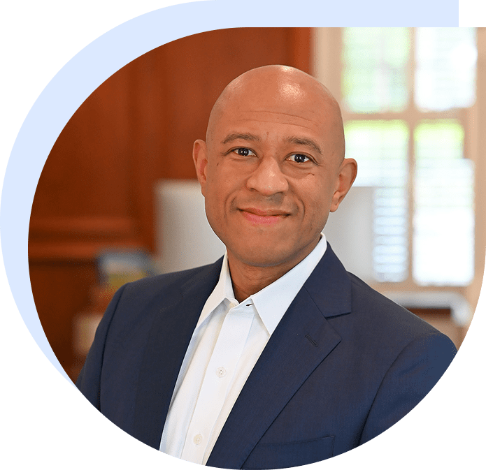 Smiling professional headshot in navy suit