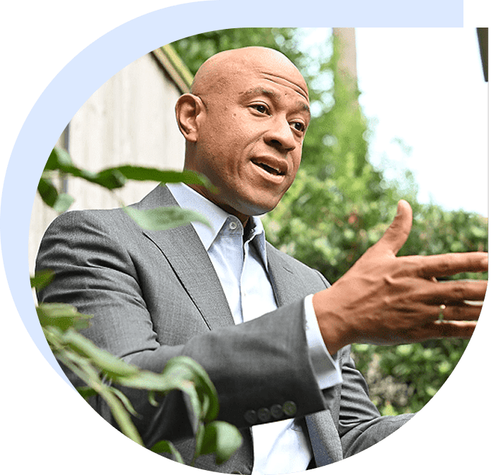 Man in suit gesturing outdoors