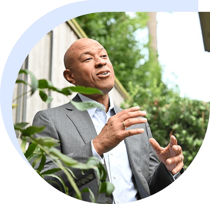 Businessman in gray suit gesturing outdoors