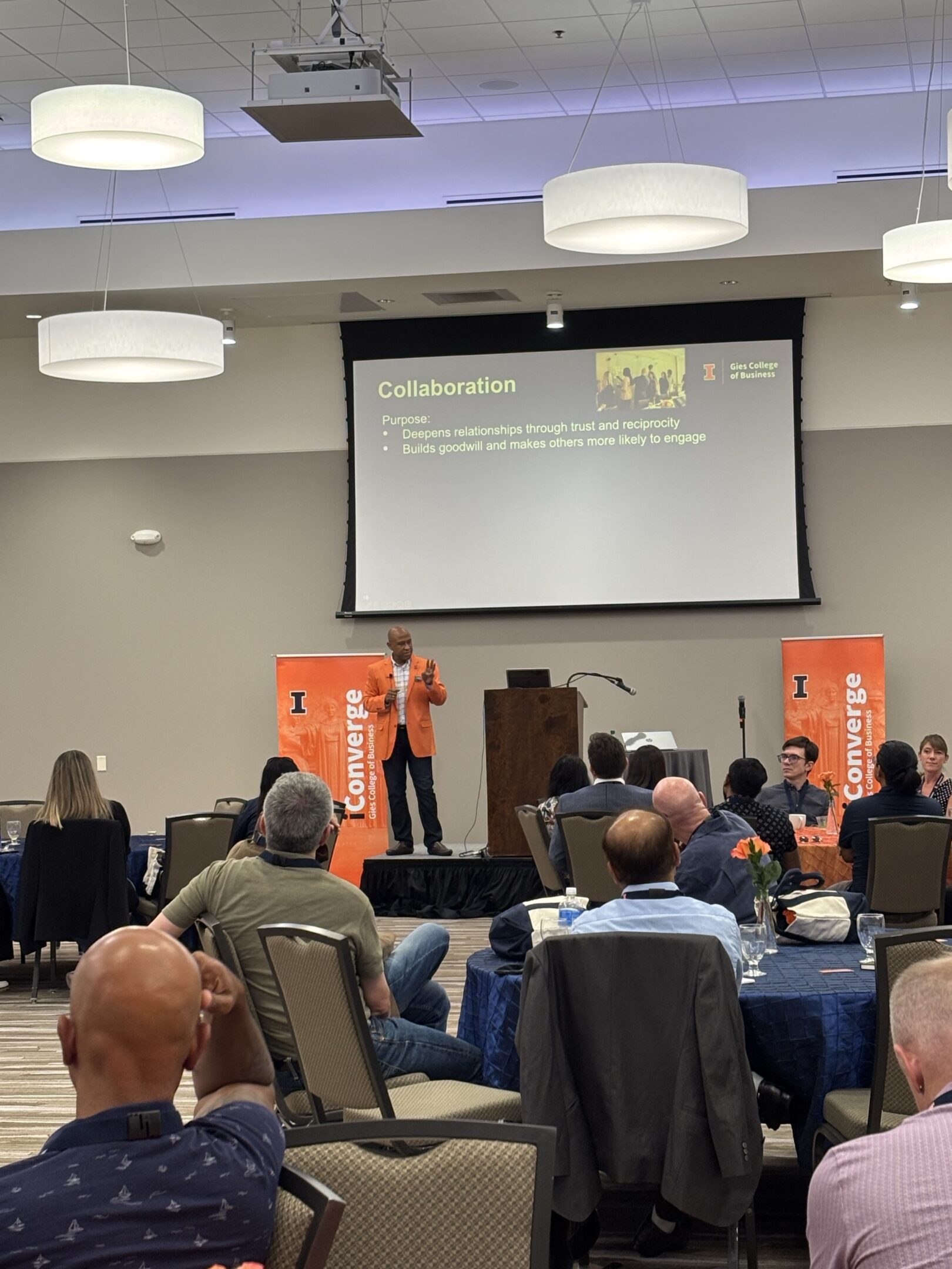 Presenter on stage with audience at conference