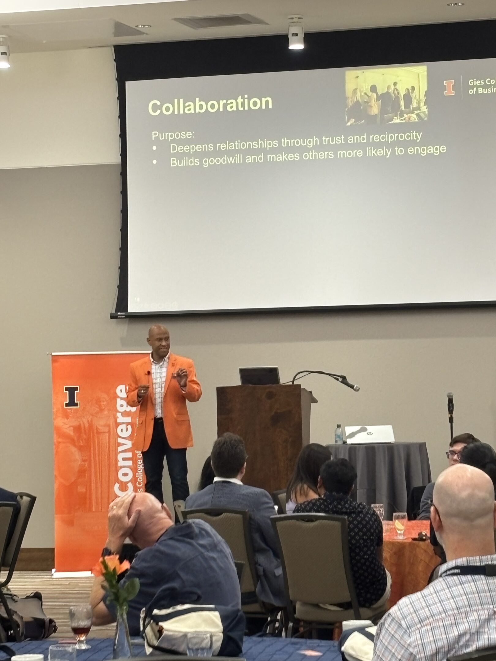 Speaker presenting collaboration slide to audience